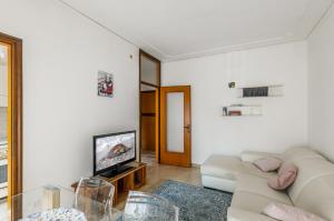 a living room with a couch and a tv at Kris- Mestre Bright Apartment with Parking! in Mestre