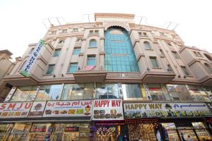 a building with a happy way sign in front of it at Cube Hotel Dubai formerly Al Buraq Hotel Al Ras in Dubai