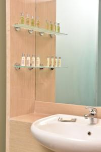 a bathroom with a sink and a mirror at DoubleTree by Hilton Turin Lingotto in Turin