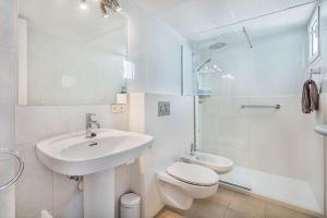 a bathroom with a sink and a toilet and a shower at Apartamento Pine walk in Port de Pollensa +11 photos
