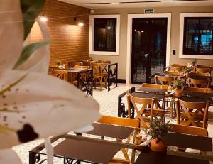 a restaurant with tables and chairs in a room at POUSADA CAFÉ DU'LIRIO in Lagoa Nova