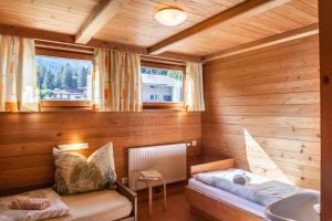 a small room with a bed and a sink at Ferienwohnung Oberangerhof in Kaltenbach