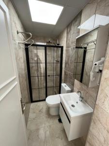 a bathroom with a toilet and a sink at Maritsa Comfort Plus in Edirne