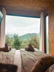 a bedroom with two teddy bears sitting on a bed at Elysian Fields - The Island Tiny House in Sadu