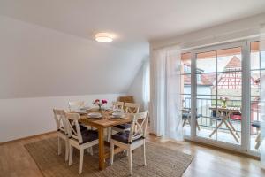 a dining room with a table and chairs and a balcony at Apartement Aposto 3 in Oberderdingen