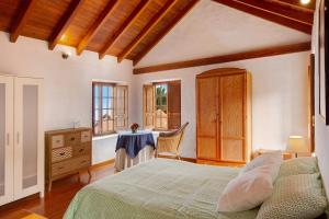 een slaapkamer met een bed, een tafel en een raam bij Las Guindas in Valverde
