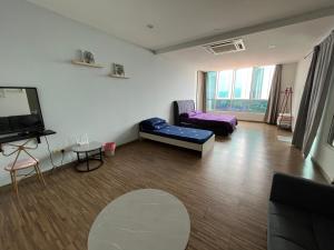 a living room with a couch and a flat screen tv at Good Mood House 3-7pax,Free Parking,upstairs Shopping Mall, Hospital Columbia, TAR University, LRT Station in Kuala Lumpur