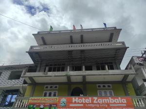 Dirang Dzong的住宿－Hotel Zambala，三人站在大楼的顶部