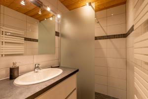 a bathroom with a sink and a mirror at Le Beauregard in Le Grand-Bornand