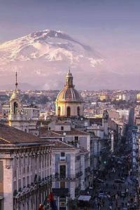a view of a city with a mountain in the background at Dimora sicula guest house in Catania