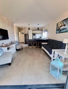 a living room with a couch and a table at 33D Kabeljauws Beach in Jeffreys Bay