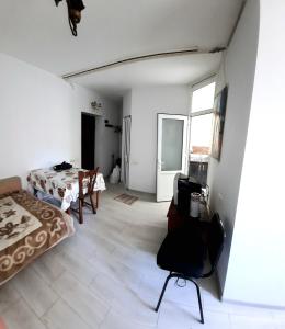 a bedroom with a bed and a table and a window at Квартира одна-комнатная in Yerevan