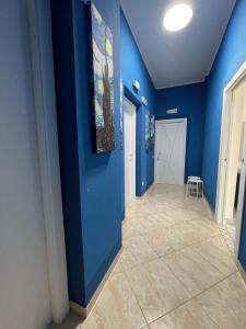un pasillo con paredes azules y suelo de baldosa en Edeler House en Pula