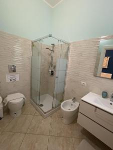 a bathroom with a shower and a toilet and a sink at Edeler House in Pula