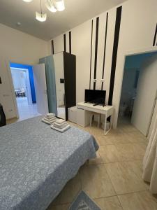 a bedroom with a bed and a desk and a television at Edeler House in Pula