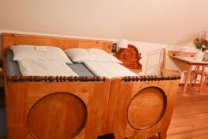 a bedroom with a wooden bed with a wooden frame at Sonnenhaus Grandl in Feldbach