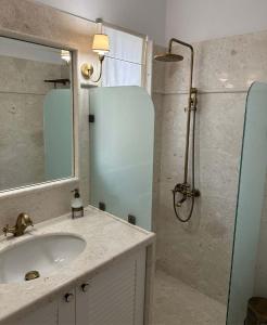 a bathroom with a sink and a shower at Villa Myrto Nafpaktos in Nafpaktos