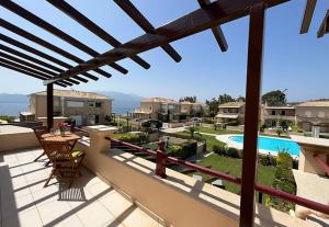 a balcony with a view of a swimming pool at Villa Myrto Nafpaktos in Nafpaktos