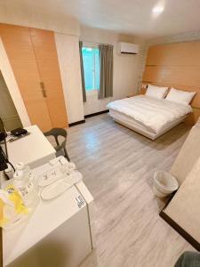 Kama o mga kama sa kuwarto sa 新獅城商務旅館New Lion City Hotel