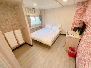 Kama o mga kama sa kuwarto sa 新獅城商務旅館New Lion City Hotel