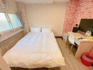 Kama o mga kama sa kuwarto sa 新獅城商務旅館New Lion City Hotel