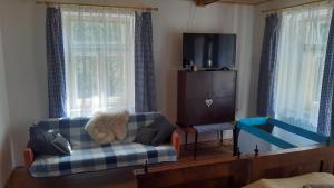 a living room with a couch and a teddy bear at Chalupa - Dešov in Desov