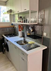 a small kitchen with a sink and a stove at Labākā vieta uz pasaules in Jūrmala