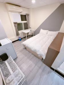 Kama o mga kama sa kuwarto sa 新獅城商務旅館New Lion City Hotel