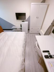 Kama o mga kama sa kuwarto sa 新獅城商務旅館New Lion City Hotel