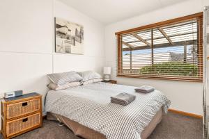a bedroom with a bed and a window at Machiya Rhyll Phillip Island in Rhyll