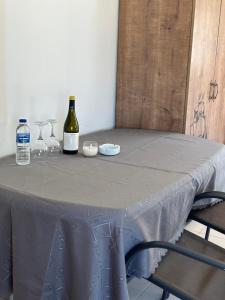 a table with two glasses and bottles of wine on it at ELIAS Penthouse in Nazareth