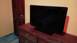 a flat screen tv sitting on top of a wooden dresser at Paso del Campo Estrellado in Humahuaca