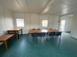 a large room with a table and chairs in it at Ubytovna SDC in Valcha