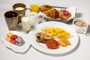 a table topped with plates of breakfast foods and coffee at Sheraton Grand Hangzhou Binjiang Hotel in Hangzhou