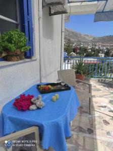 a blue table with a tray of fruit on it at Valentino in Kalymnos