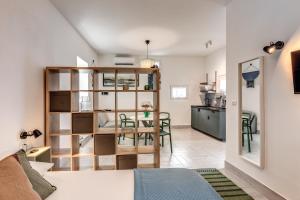 a studio apartment with a dining room and kitchen at Vesuvio Home Capodichino in Naples