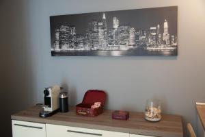 a desk with a red chair and a picture of a city at Cimoneight in Varese