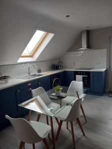 a kitchen with a table and chairs and a window at Lakeland Lodge in Derrylin