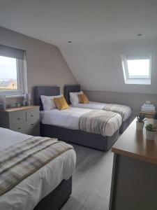 a bedroom with two beds and a window at Lakeland Lodge in Derrylin