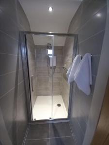 a shower with a glass door in a bathroom at Lakeland Lodge in Derrylin +30 photos
