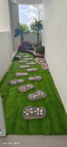a row of stepping stones on grass in a hallway at The Garden Emerald Avenue Cameron Highlands 6Pax 910 Wifi in Brinchang
