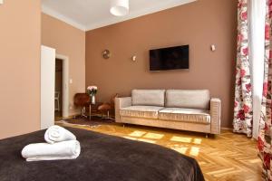 a living room with a bed and a couch at Mikołajska 5 Apartments in Krakow
