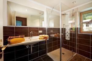 a bathroom with a sink and a shower at Gästehaus am Brunnen in Bad Hindelang +20 photos