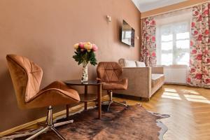 a living room with a couch and a table and chairs at Mikołajska 5 Apartments in Krakow