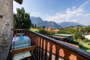 a balcony with a table and a view of mountains at Cascina Taronico in Bellagio