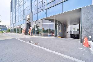 a large glass building with people standing outside of it at Browndot Signature Hotel in Changwon