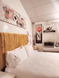 a bedroom with a bed with white pillows at 147@ Simon Bekker Kosmos in Hartbeespoort