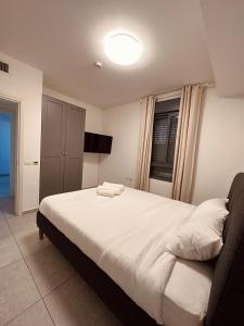 a bedroom with a bed with two towels on it at Lincoln Design Apartments in Jerusalem