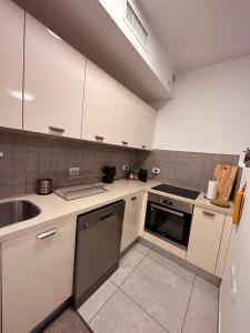 a kitchen with white cabinets and a sink at Lincoln Design Apartments in Jerusalem