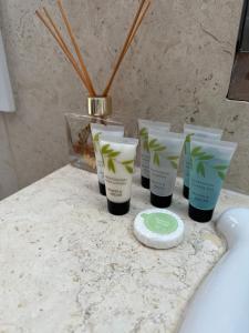 a group of four products sitting on a bathroom counter at Studio flat in the heart of Hampstead, London in London